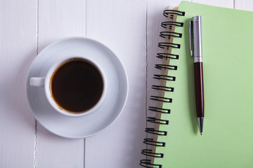 coffee notebook pen on wooden background