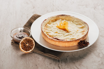 delicious flan cake with caramel and star anise on white plate