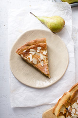 A slice of tart with poached pears and almond frangipane