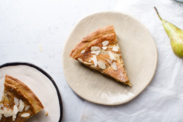 A slice of tart with poached pears and almond frangipane