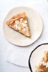 A slice of tart with poached pears and almond frangipane
