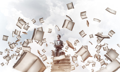 Young businessman or student studying the science and books fly 