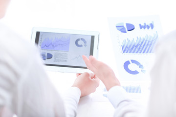close up.businessman pointing with pen on a digital tablet screen.