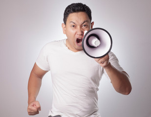 Young Man Shouting with Megaphone, Angry Expression