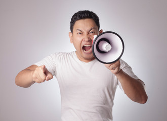 Young Man Shouting with Megaphone, Angry Expression