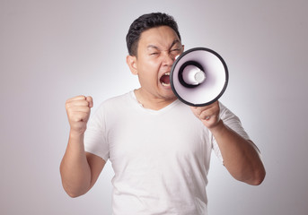 Young Man Shouting with Megaphone, Angry Expression