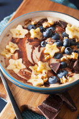 healthy banana smoothie bowl with blueberry chocolate walnuts