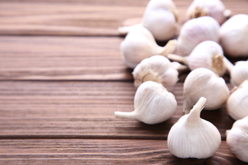 Fresh garlic on a brown wooden background