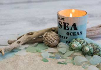 Beach still life with candle, shells and driftwood