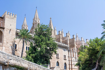 Fototapeta na wymiar Palma de Mallorca, Balearic Islands, Spain - July 21, 2013: Royal Palace of La Almudaina and Cathedral of St. Mary of Palma