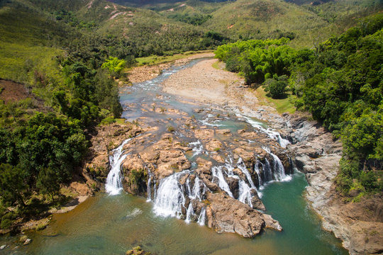 Impressive waterfalls on Koua river aerial view, between Poro and Kouaoua, North Province, New Caledonia, Melanesia, Oceania, overseas territory of France, South Pacific Ocean.