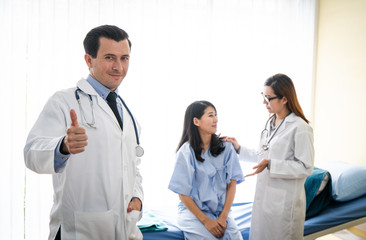 Team of doctor examining a female patient on bed in hospital