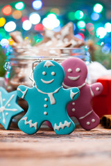 Naklejka premium Christmas cookies, gift box and lights on wooden table