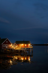 Obraz premium Traditional red wooden houses, Rorbuer in the small fisherman village in Lofoten islands,Norway.