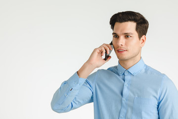 Happy business man talking on phone.