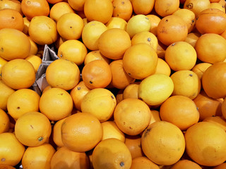 Orange fresh citrus fruits lie in the shop window