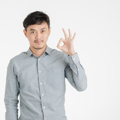 Fototapeta premium Young man makes okay hand sign.