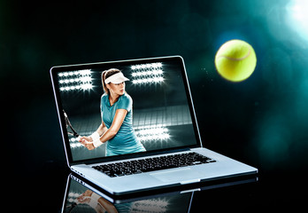 Sports tennis player with racket in blue costume. Woman atlete. Laptop on the table with design for bookmaker advertising. - Powered by Adobe