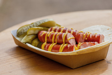 Tortilla with grilled sausages and pickled cucumbers.