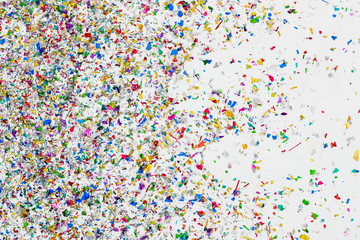 colorful glitter and confetti on white background