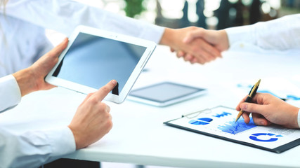 successful contract. handshake on the background of workplace wi