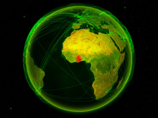 Ghana from space on planet Earth with digital network representing international communication, technology and travel.