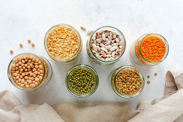 Glass jars full of assorted dried legumes