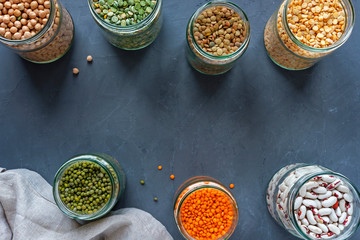 Jars of assorted dried lentils forming a border