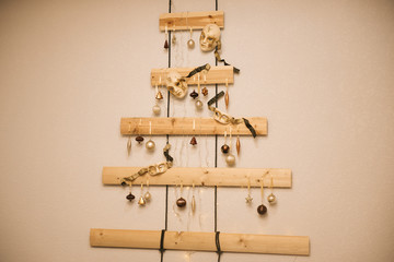 Wooden Christmas tree hanging on the wall in the cafe