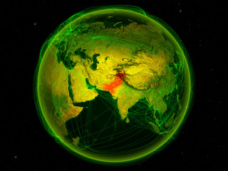 Pakistan from space on planet Earth with digital network representing international communication, technology and travel.