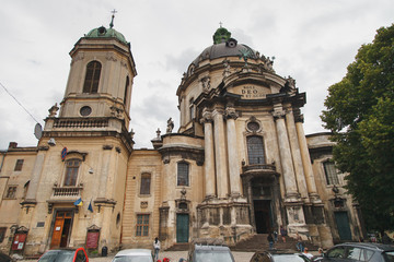 Fototapeta premium UKRAINE, LVIV, APRIL 5, 2015: People near Dominican church and monastery in old town of Lviv, Western Ukraine