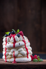 Pavlova dessert on wooden background with copy space
