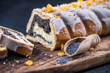 Traditional poppy seed roll, with icing and candided fruits