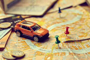 travel concept - small toy car on the map