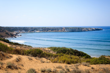 View of the large protected sandy beach of Lara, on which the caretta caretta turtles hatch and the blue Mediterranean Sea on the island of Cyprus