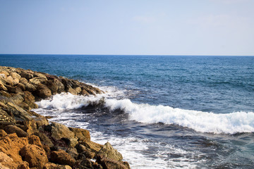 Fototapeta premium Waves of the Mediterranean Sea crashing on the rocky coast of the island of Cyprus