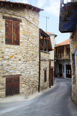 Fototapeta na wymiar Long narrow streets consisting of old stone houses built in one line in a village in the mountains on the island of Cyprus