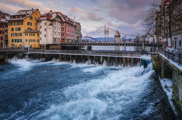 Historic center of Lucerne with view of the dam and bridge on river Reuss. Old Swiss houses and...