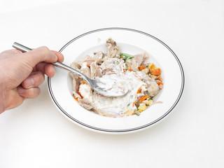 Hand, spoon and plate