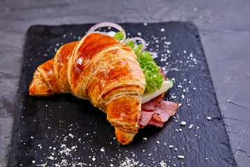 croissant with ham in the cafe