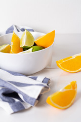 lime and orange in a plate on a white background.