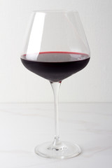a glass of red wine on a white background.