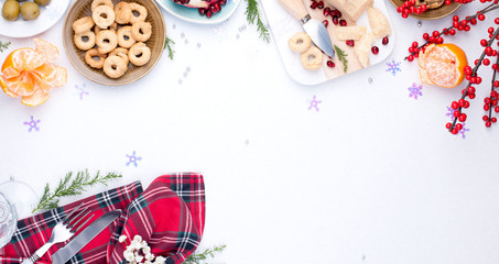 Different appetizers and razdnichnaya table setting for a party. Celebration of Christmas in the company. Table with food top view. Free space for text in the center.