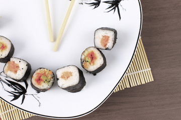 Traditional Japanese cuisine, sushi on wooden background