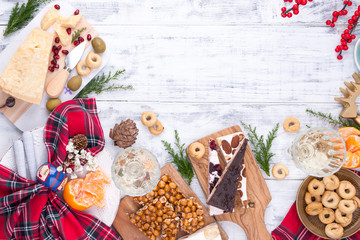 Different appetizers and razdnichnaya table setting for a party. Celebration of Christmas in the company. Table with food top view. Free space for text in the center.