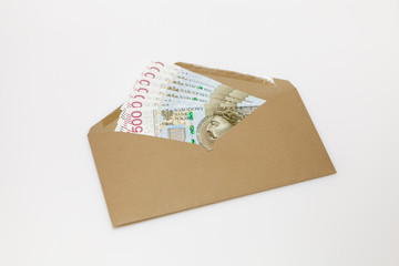 Banknoty 500 PLN w brązowej kopercie na białym tle
