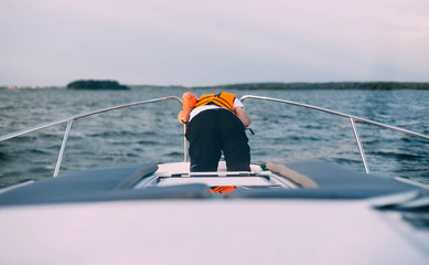  man sick on a yacht at sea. Seasickness. Danger of traveling by boat, swayed. - obrazy, fototapety, plakaty