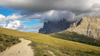 Dolomites, South Tyrol, Italy, Europe. View over the high altitude meadows with hiking trails and the Geislergruppe / Gruppo delle Odle mountainrange. Near Ortisei