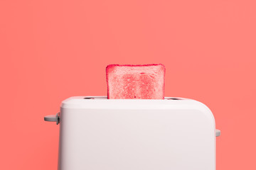 Living Coral color of the Year 2019. Creative concept Healthy fashion food of breakfast. Toast in a toaster on a pink background. Gradient color palette.