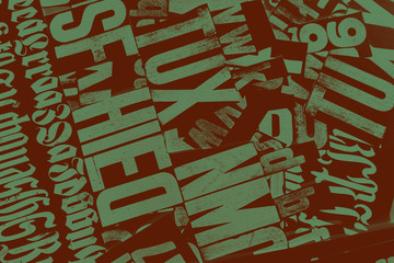 Newspaper, green print on a brown background.